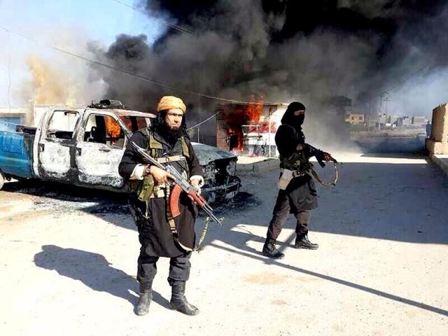 Shakir-Waheib-a-senior-member-of-the-al-Qaida-breakaway-group-Islamic-State-of-Iraq-and-the-Levant-ISIL-left-next-to-a-burning-police-vehicle-in-Iraq-s-Anbar-Province-AP-Photo Shakir-Waheib-a-senior-member-of-the-al-Qaida-breakaway-group-Islamic-State-of-Iraq-and-the-Levant-ISIL-left-next-to-a-burning-police-vehicle-in-Iraq-s-Anbar-Province-AP-Photo
