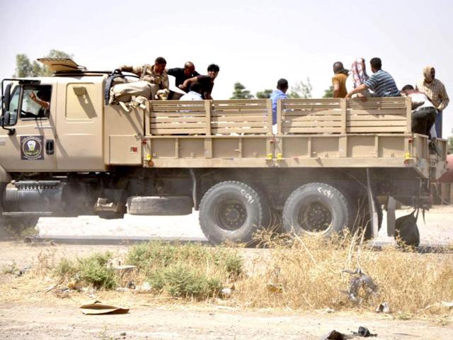 Iraqi security forces leave a military base as Kurdish forces take over control in Kirkuk. (Reuters Photo)