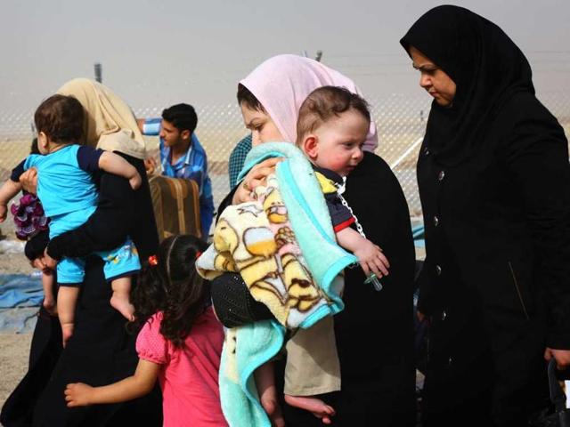 Families fleeing the violence in the Iraqi city of Mosul arrive at a checkpoint on the outskirts of Arbil, in Iraq's Kurdistan region. Iraqi Kurds took control of the northern oil city of Kirkuk on Thursday after government forces abandoned their posts in the face of a sweeping Sunni Islamist rebel push towards Baghdad that threatens Iraq's future as a unified state. (Reuters)