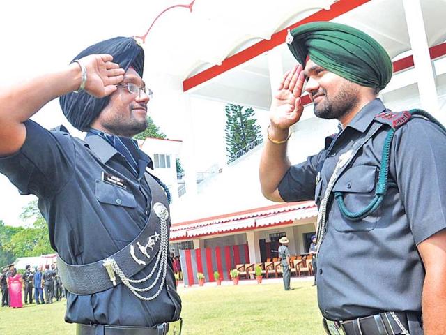 Younger brother Kritpal Singh and elder brother Karamjeet Singh (in spectacle) salute each other, in Dehradun on Saturday.