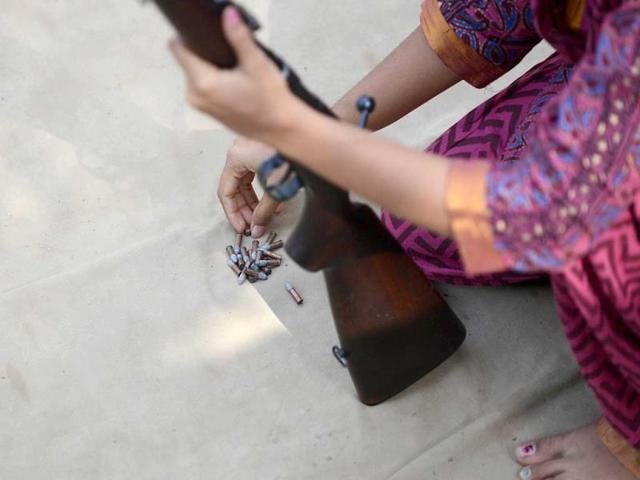 A participant loads a .22 bore rifle with ammunition during a five-day firearms training programme for women aged 15 and above at the Ahmedabad City Police firing range in Ahmedabad. (AFP photo)