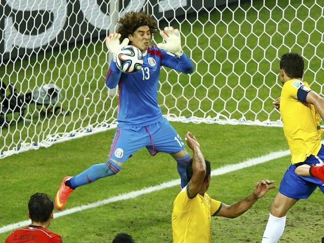 Mexico-s-Guillermo-Ochoa-L-deflects-the-ball-during-a-goal-attempt-by-Brazil-s-Thiago-Silva-top-R-during-their-World-Cup-Group-A-match-at-the-Castelao-arena-in-Fortaleza-Reuters-Photo