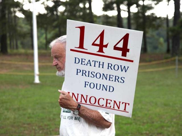 An-unidentified-death-penalty-opponent-stands-on-the-grounds-of-the-Georgia-Diagnostic-and-Classification-Prison-in-Jackson-Ga-AP-Photo An-unidentified-death-penalty-opponent-stands-on-the-grounds-of-the-Georgia-Diagnostic-and-Classification-Prison-in-Jackson-Ga-AP-Photo