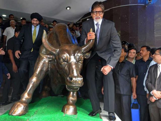 Amitabh Bachchan poses with the bull statue at BSE during a promotional event of his TV show Yudh. (PTI Photo)