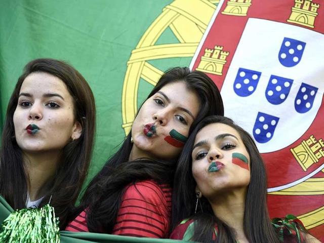 Portugal fans pose prior to the match between Germany and Portugal at the Fonte Nova Arena in Salvador during the FIFA World Cup. (AFP Photo) 