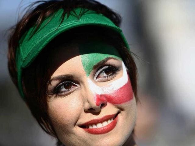 An Iranian fan cheers outside Baixada Arena in Curitiba before the match between Iran and Nigeria. (AFP Photo) 