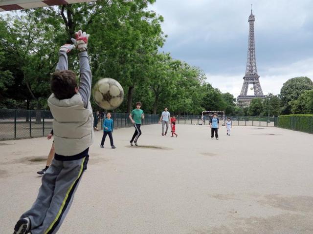 France, Paris: People play football in front of the Eiffel tower. (AFP PHOTO)