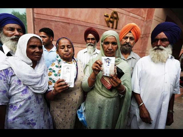 Relatives-hold-up-photographs-of-Indian-workers-who-have-been-kidnapped-in-Iraq-after-their-meeting-with-India-s-Foreign-Minister-Sushma-Swaraj-in-New-Delhi-Reuters-Photo Relatives-hold-up-photographs-of-Indian-workers-who-have-been-kidnapped-in-Iraq-after-their-meeting-with-India-s-Foreign-Minister-Sushma-Swaraj-in-New-Delhi-Reuters-Photo