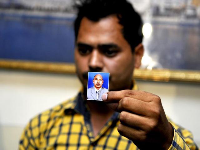 Family member of one of the Indians who has reportedly been abducted in Iraq, holding a photograph of his kin during a visit to Rakab Ganj Gurudwara, in New Delhi. (Sonu Mehta/ HT Photo)
