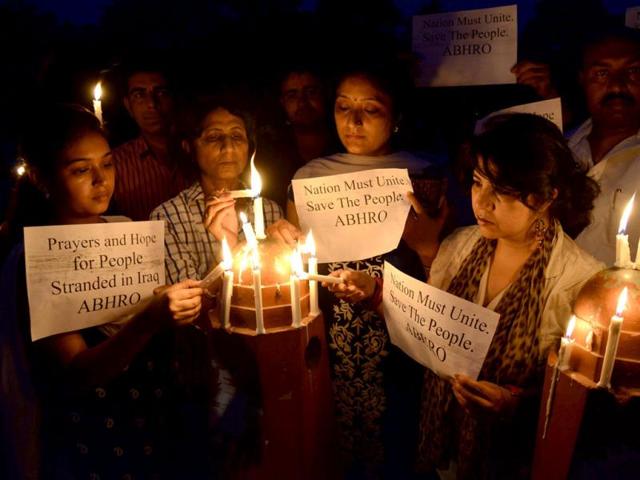 Members of Akhil Bhartiya Human Rights Organisation (ABHRO) hold candles and placards as they demonstrate for the early release of 40 Indian workers abducted in Iraq, in Amritsar. (AFP Photo)