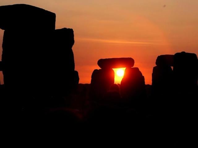 The sun rises against the Stonehenge near Salisbury, England, to celebrate the summer solstice, the longest day of the year on June 21. (AP photo)