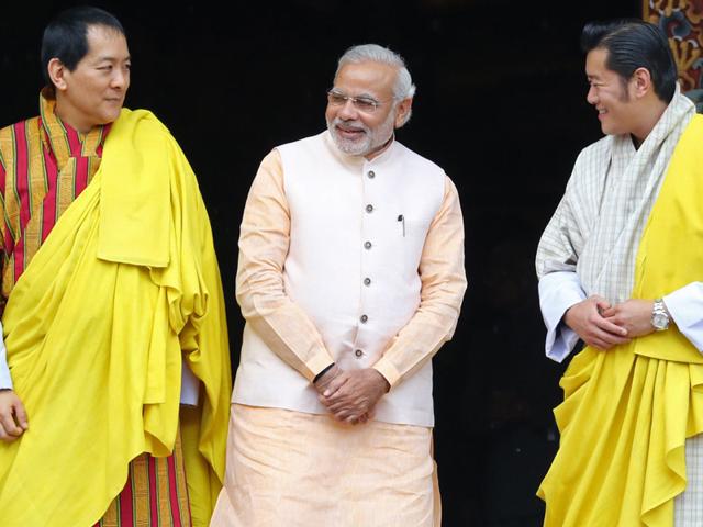 Prime-Minister-Narendra-Modi-gestures-as-he-meets-by-Bhutanese-Prime-Minister-Tshering-Tobgay-at-Paro-Airport-in-Bhutan-AFP-Photo