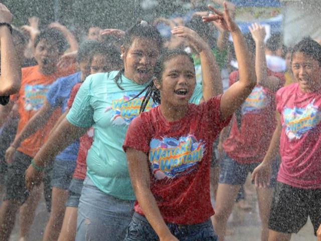 Residents are sprayed with water as they celebrate the feast day of St John the Baptist in Manila. Residents traditionally greet everyone with splashing water in a belief that it is a way of spreading good blessings on St John's Day. (AFP photo)