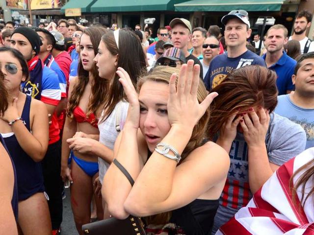 US fans watching from Hermosa Beach, California react to Thomas Muller's goal for Germany against the United States during their first round match. (AFP Photo) US fans watching from Hermosa Beach, California react to Thomas Muller's goal for Germany against the United States during their first round match. (AFP Photo)