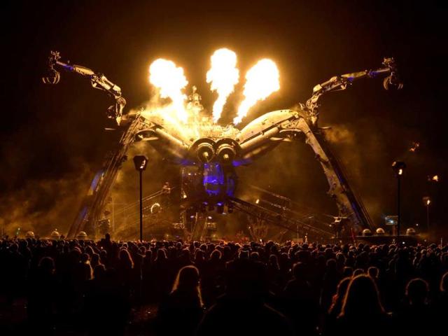 Revellers enjoy the pyrotechnic display as they dance to the music at the the Glastonbury Festival of Music and Performing Arts in Somerset, southwest England. (AFP Photo)