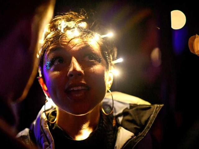 A girl wears LED lights and dances, on the second day of the festival. (AFP Photo)