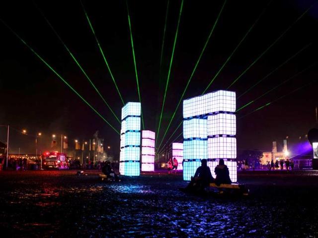 Revellers sit near light sculptures at the Glastonbury Festival. (AFP photo)