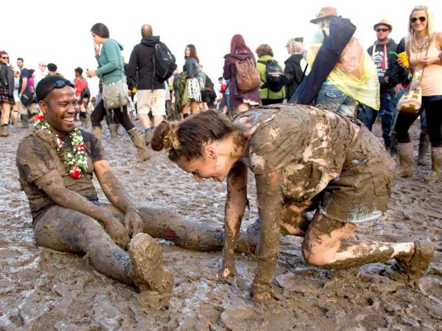 Festival goers react after falling over in the mud close to the Pyramid stage at Glastonbury music festival, England. Thousands of music fans have arrived for the festival to see headliners Arcade Fire, Metallica and Kasabian. (Photo AP) Festival goers react after falling over in the mud close to the Pyramid stage at Glastonbury music festival, England. Thousands of music fans have arrived for the festival to see headliners Arcade Fire, Metallica and Kasabian. (Photo AP)