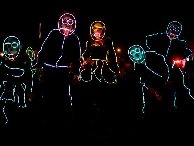 People wear neon body outlines as they walk through the site, on the second day of the Glastonbury Festival of Music and Performing Arts in Somerset, southwest England. (AFP photo) People wear neon body outlines as they walk through the site, on the second day of the Glastonbury Festival of Music and Performing Arts in Somerset, southwest England. (AFP photo)