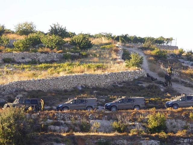 Israeli soldiers keep guard near the West Bank city of Hebron. Israeli aircraft bombed dozens of sites in the Gaza Strip on Tuesday, the military said, and troops opened fire and killed a Palestinian during an arrest raid in the occupied West Bank, Palestinian medics said. (Reuters)