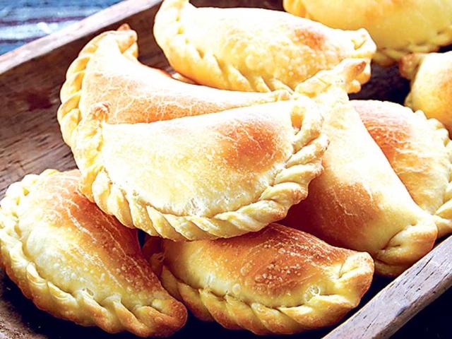 EMPANADAs DE PINO, ChileEmpanadas De Pino are the most popular variety of empanadas consumed in Chile. Pino, the filling, is a combination of beef, eggs, peppers, onions, olives and hot sauce. The empanada dough is prepared using flour, salt, sugar, butter, water and eggs, and the &shy;filling is stuffed before you either fry or bake it. You can also add cheese and butter, along with any filling of your choice, to &shy;create variations. The name comes from the Spanish term ‘empanar’ that means to coat in breadcrumbs.