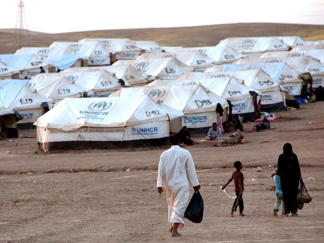 An Iraqi family fleeing violence in the northern city of Tal Afar, arrive at the Kurdish checkpoint in Aski kalak, 40 km West of Arbil, in the autonomous Kurdistan region. Saudi Arabia pledged $500 million in humanitarian aid for Iraq to be disbursed through the United Nations to those in need regardless of sect or ethnicity, state media reported. (AFP photo)