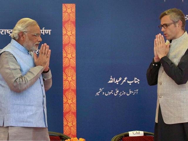 PM Narendra Modi and chief minister of Jammu and Kashmir Omar Abdullah greet at the inauguration of the Katra railway station in Katra, Jammu. (AFP photo)