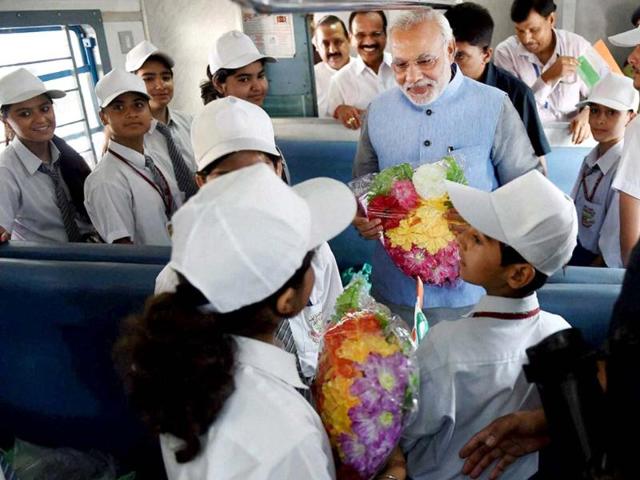 Prime Minister Narendra Modi interacts with children on board the inaugural train on the Katra-Udhampur rail link. (PTI photo)