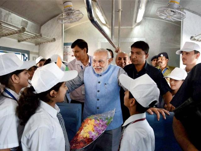 PM Narendra Modi interacts with children on board the inaugural train on the Katra-Udhampur rail link. (PTI photo)
