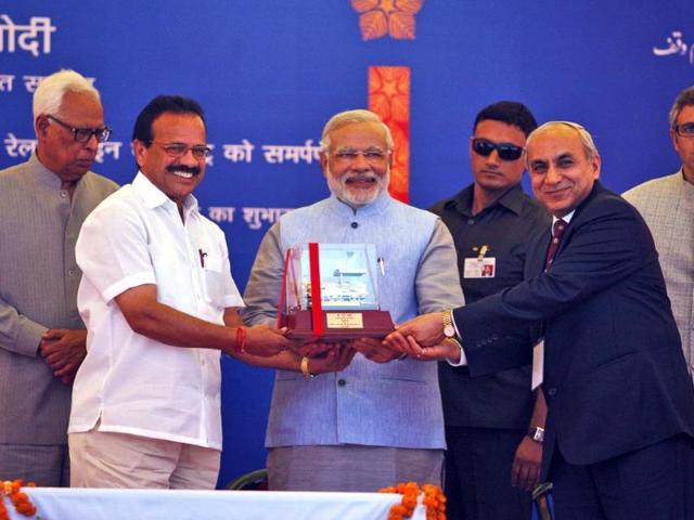 Railway minister Sadananda Gowda, second left, presents a memento to PM Narendra Modi in Katra, 45 kms from Jammu. (AP photo)