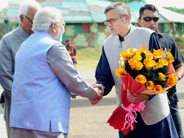 PM Narendra Modi being received by the CM of Jammu and Kashmir, Omar Abdullah on his arrival at the airport in Jammu. (PTI photo)
