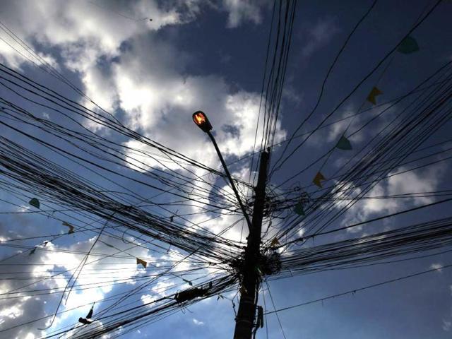 A lamppost is surrounded by electric cables during the 2014 World Cup Group A soccer match between Brazil and Cameroon at Corrilhos favela, near Sao Paulo's World Cup stadium, in Sao Paulo. In a project called 'On The Sidelines' Reuters photographers share pictures showing their own quirky and creative view of the 2014 World Cup in Brazil. (Reuters)