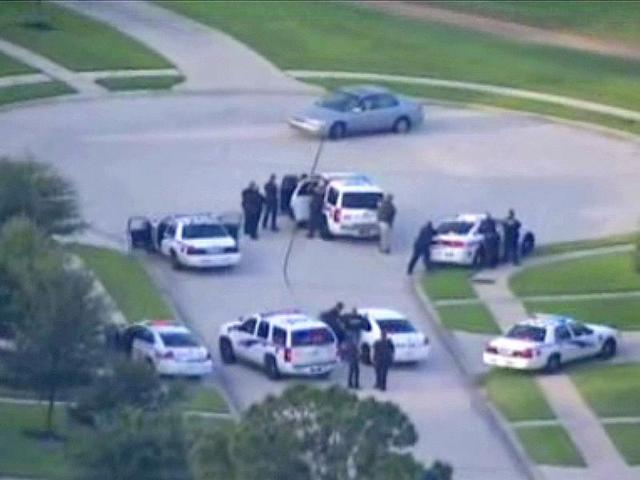 An-image-taken-from-KPRC-TV-aerial-video-footage-shows-police-and-a-suspect-in-a-standoff-at-a-residential-neighbourhood-following-a-shooting-incident-in-Spring-Texas-Reuters-photo