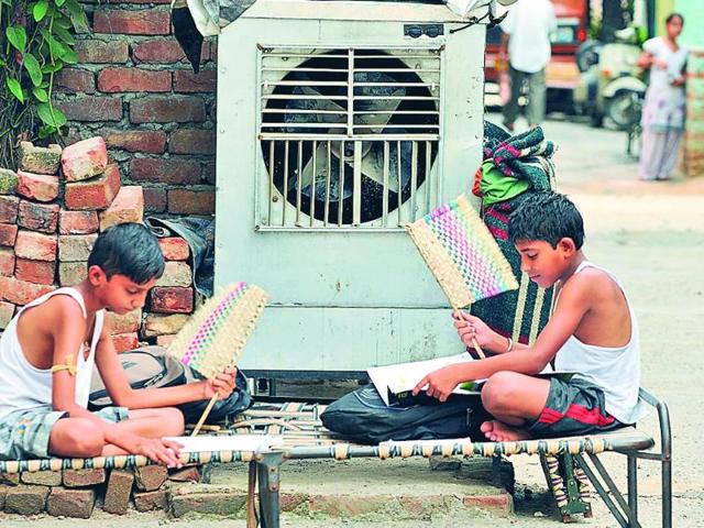 Children-using-hand-made-fans-during-an-unscheduled-power-cut-in-Jalandhar-on-Friday-The-power-demand-supply-gap-is-widening-by-the-day-Pardeep-Pandit-HT