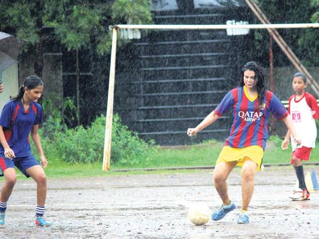 Taking advantage of the flavour of the season –– football –– Rakhi Sawant hit the ground for a game with underprivileged girls. (HT Photo)