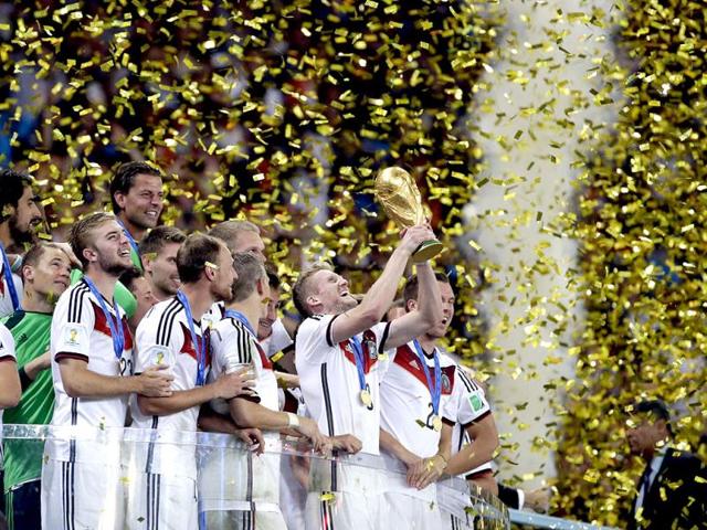 Germany's Andre Schuerrle holds up the World Cup trophy as the team celebrates their 1-0 victory over Argentina after the Fifa World Cup final match between Germany and Argentina at the Maracana Stadium in Rio de Janeiro, Brazil. (AP Photo)