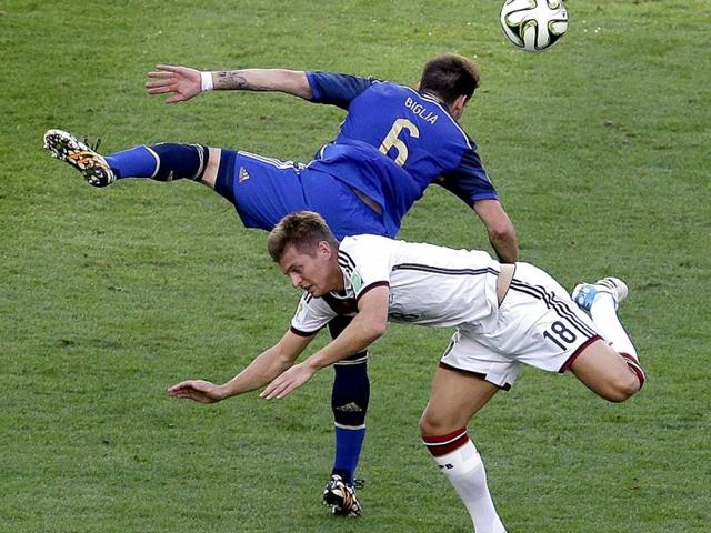 Germany's Toni Kroos and Argentina's Lucas Biglia go for a header during the Fifa World Cup final match between Germany and Argentina at the Maracana Stadium in Rio de Janeiro, Brazil. (AP Photo)