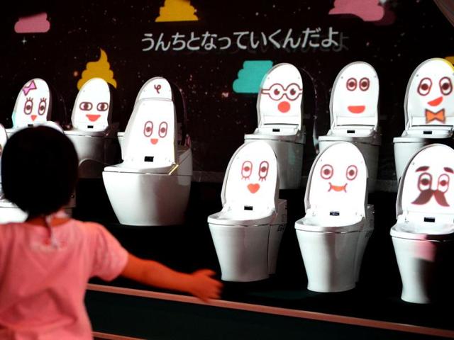 A-child-dances-as-she-listens-to-a-song-by-toilet-bowls-at-a-toilet-exhibition-at-the-National-Museum-of-Emerging-Science-and-Innovation-in-Tokyo-AFP