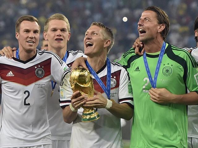 Germany's Bastian Schweinsteiger celebrates with the trophy after the World Cup final soccer match between Germany and Argentina at the Maracana Stadium in Rio de Janeiro, Brazil on July 13, 2014. (AP Photo/Martin Meissner)