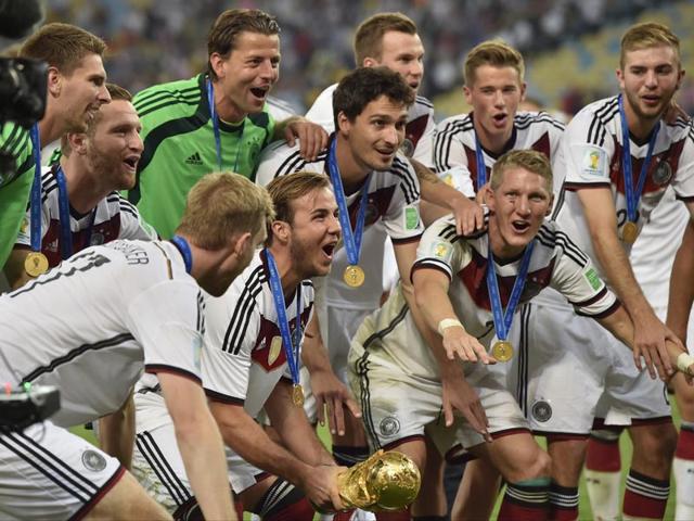 Germany's Mario Goetze, centre, and teammates celebrate with the trophy after the World Cup final between Germany and Argentina on July 13, 2014. Germany won the match 1-0. (AP Photo/Martin Meissner)