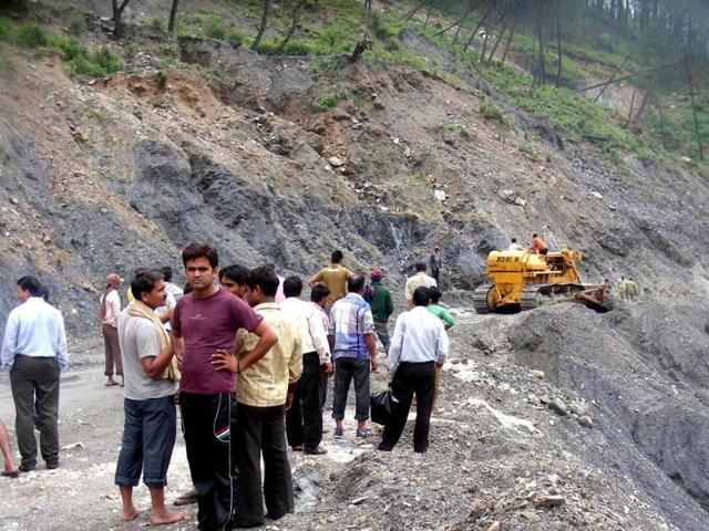 Machines clear a closed road at Gangotri highway in Uttarkashi district. (Santosh Bhatt/HT photo)