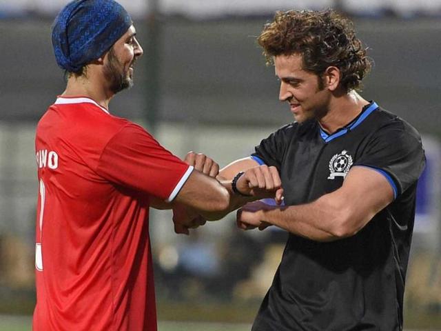 Bollywood actors Hritik Roshan and Dino Morea during a charity football match in Mumbai on Sunday. (PTI)