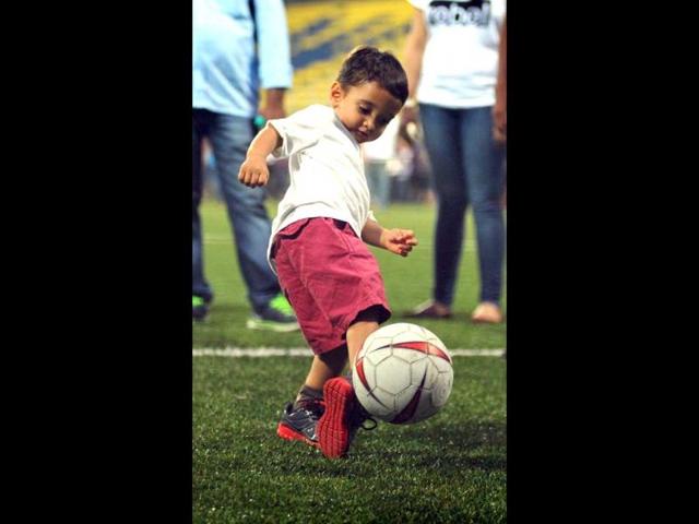 Bollywood film director Kiran Rao's son, Azad Rao Khan plays at a charity football match organized by Ira Khan, daughter of film actor Aamir Khan in Mumbai on July 20, 2014. (AFP)