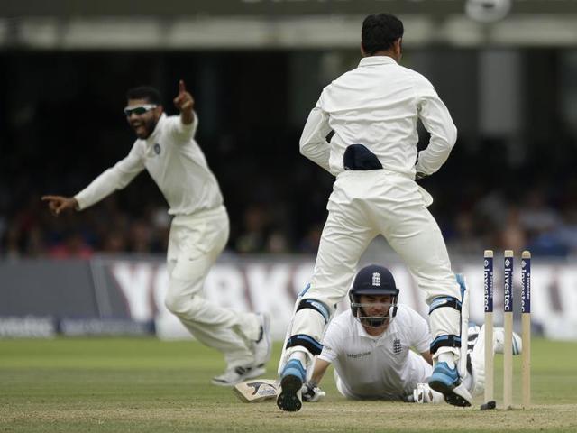 Ravindra Jadeja celebrates after running out England's James Anderson to win the test match as Mahendra Singh Dhoni watches on the fifth day of the second cricket test match between at Lord's cricket ground (AP Photo)