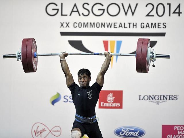 India's gold medalist Sukhen Dey makes a successful lift during the men's weightlifting 56kg class at the SECC Precinct (AFP Photo)