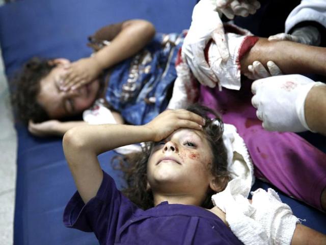 Palestinian children, wounded in an Israeli strike on a compound housing a UN school in Beit Hanoun, in the northern Gaza Strip, are treated as they lay on the floor at the emergency room of the Kamal Adwan hospital in Beit Lahiya. (AP photo)
