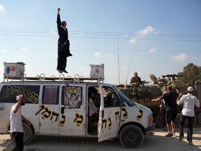 Israel, Israel-Gaza Border: Israeli soldiers dance with Orthodox Jews who came to show their support at an army deployment near Israel's border with the Gaza Strip, on July 20, 2014. It was the bloodiest single day in the battered enclave in five yearstaking the Palestinian toll on the 13th day of Israel's Gaza offensive to 438. (AFP/Menahem Kahana)