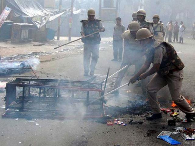 Policemen douse the fire at a rack after violent clashes broke out between two communities over a land dispute in Saharanpur. (PTI photo)