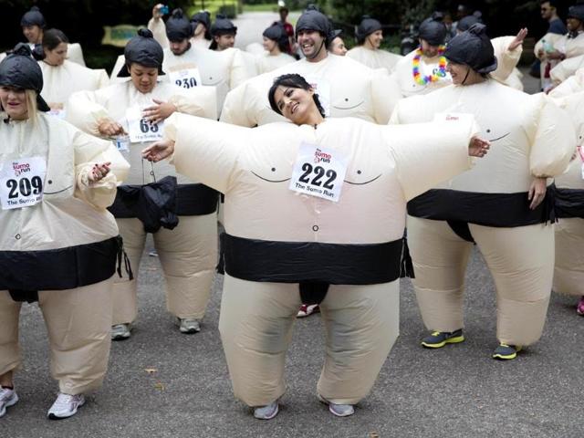 Participants warm up before The Sumo Run in Battersea Park, London. (Reuters)