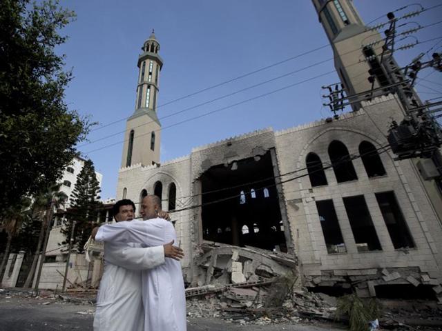 Palestinians react in front of a destroyed mosque after it was hit by an Israeli air strike on July 29, 2014, in Gaza City. (AFP/Mahmud Hams)